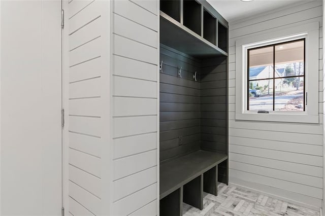 mudroom featuring wood walls