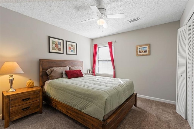 carpeted bedroom featuring a textured ceiling, a closet, visible vents, and baseboards