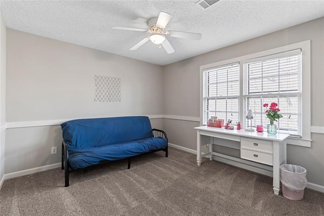 sitting room with a textured ceiling, carpet flooring, and visible vents