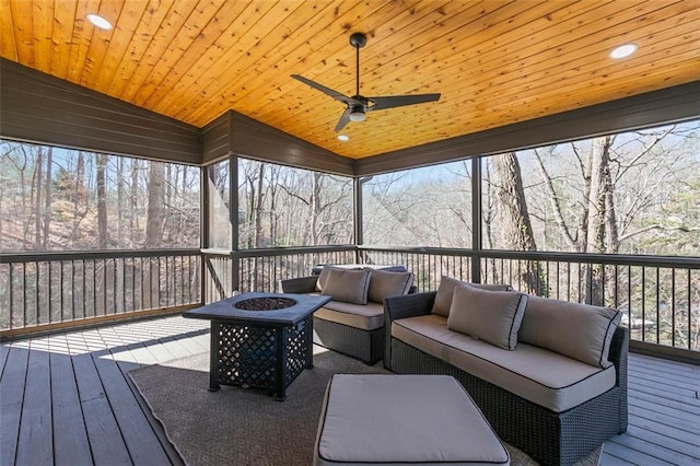 sunroom with vaulted ceiling, ceiling fan, and wooden ceiling