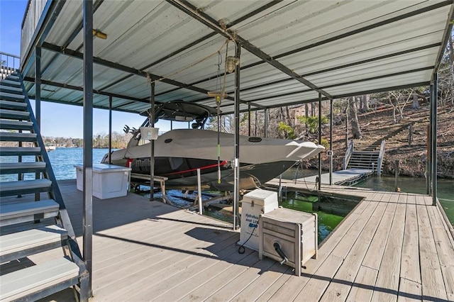 dock area with stairway, a water view, and boat lift