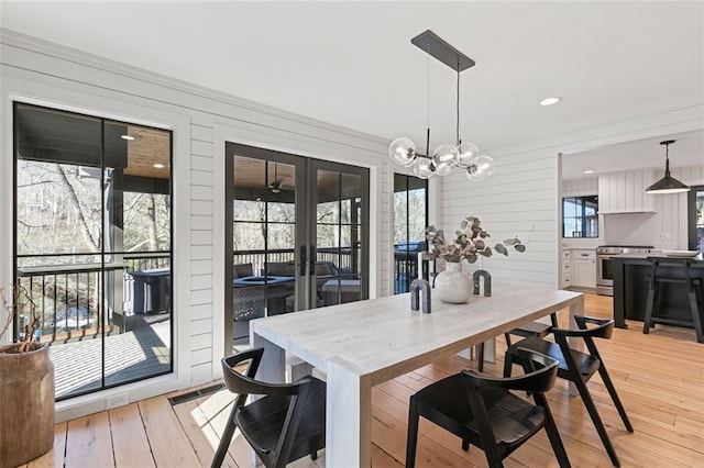 dining room featuring a wealth of natural light, french doors, light wood-style flooring, and recessed lighting