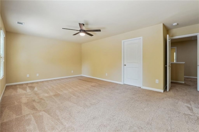 interior space with ceiling fan and light colored carpet