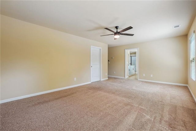 carpeted empty room featuring ceiling fan