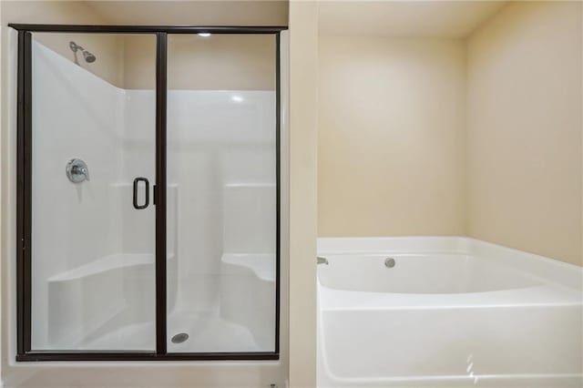 bathroom with shower with separate bathtub