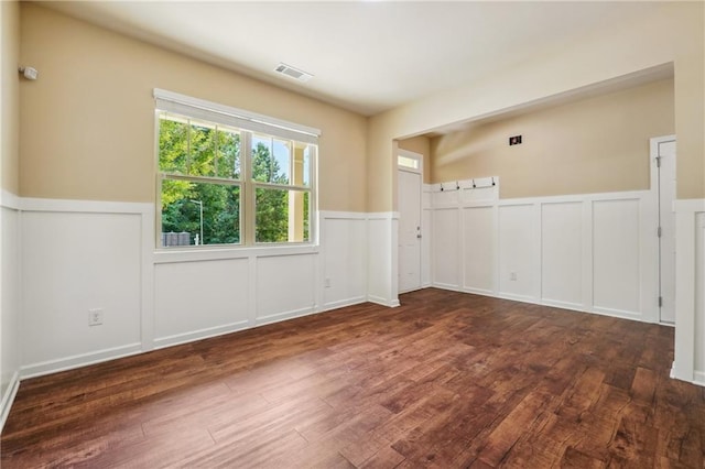 empty room with dark hardwood / wood-style floors