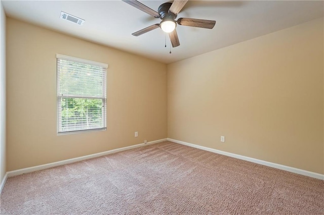 spare room featuring ceiling fan and carpet flooring