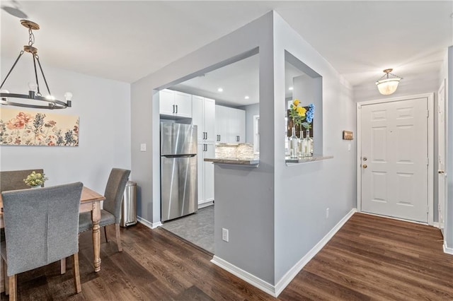 dining room with baseboards, recessed lighting, dark wood finished floors, and a notable chandelier