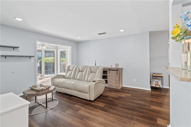 living area with recessed lighting, visible vents, baseboards, and wood finished floors