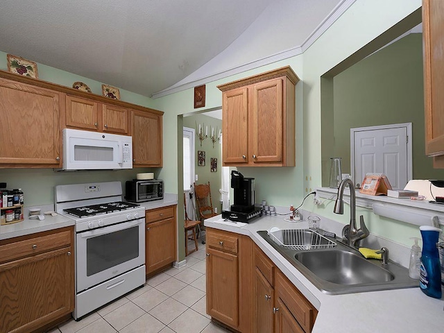37 Montana Dr, Cedartown, GA 30125 - kitchen featuring white appliances, a sink, vaulted ceiling, light tile patterned flooring, and light countertops