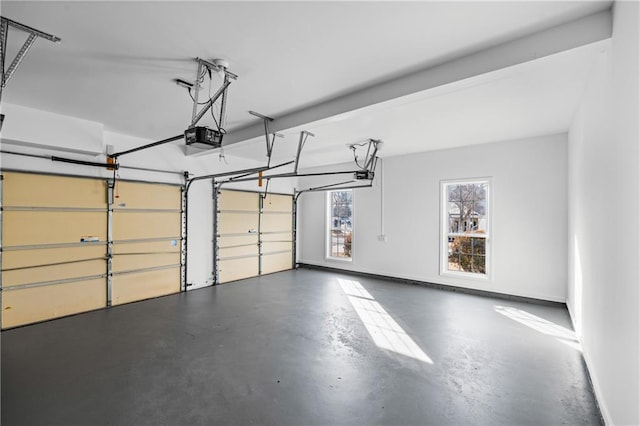 garage with a garage door opener and baseboards