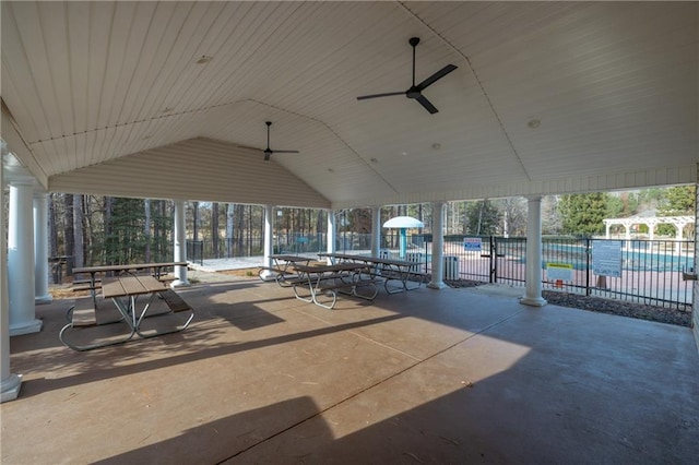 view of patio / terrace with a pool, a ceiling fan, and fence