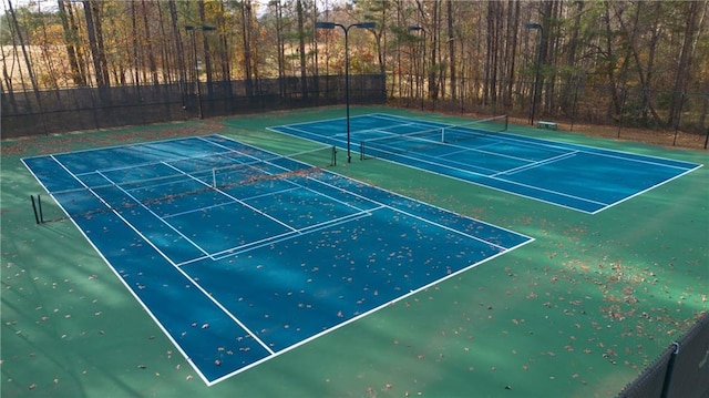 view of tennis court featuring fence