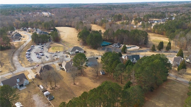 birds eye view of property featuring a view of trees