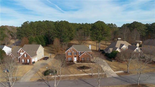 birds eye view of property with a wooded view