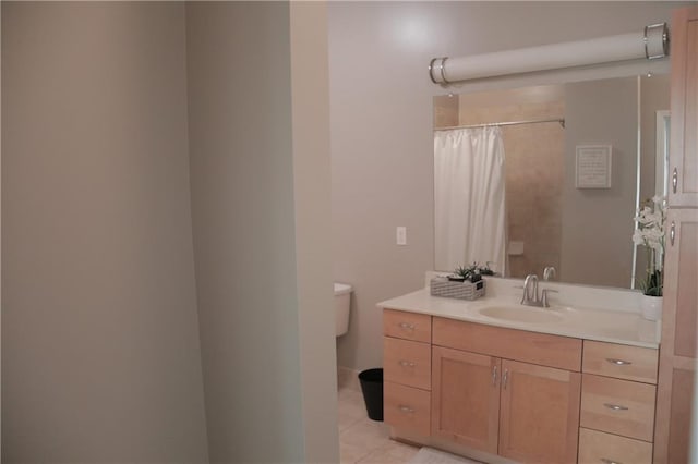 bathroom featuring tile patterned floors, vanity, a shower with shower curtain, and toilet