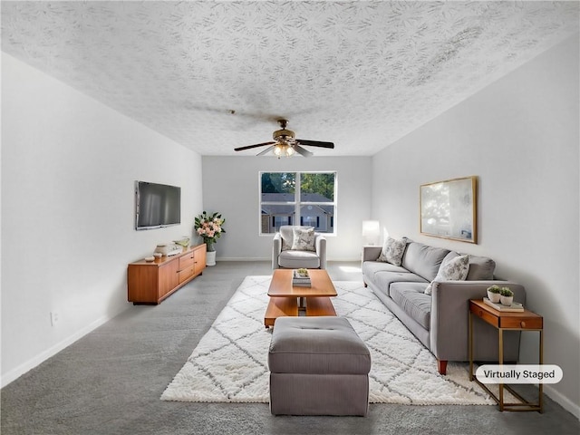 living room with carpet flooring, a textured ceiling, and ceiling fan