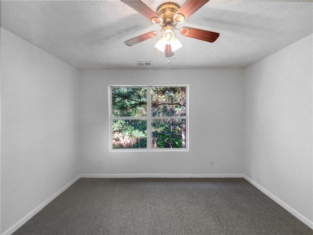 carpeted empty room featuring a textured ceiling and ceiling fan