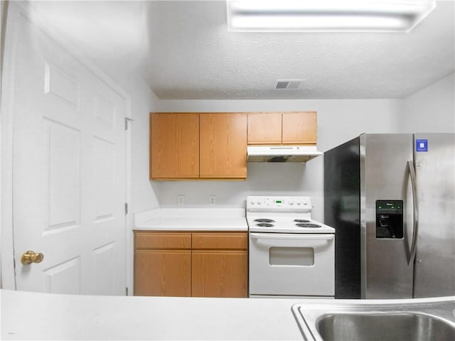 kitchen with stainless steel refrigerator with ice dispenser, a textured ceiling, and electric range