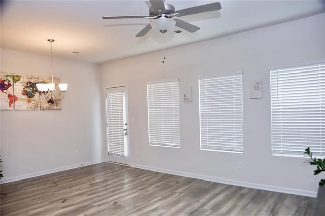 unfurnished room featuring wood-type flooring and ceiling fan with notable chandelier