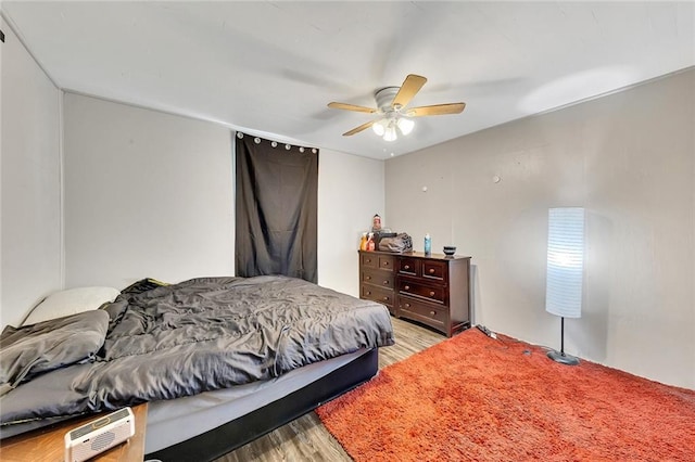 bedroom with light hardwood / wood-style flooring and ceiling fan