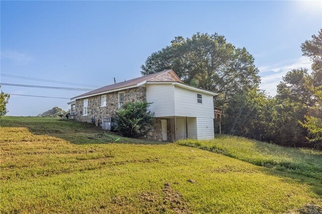 view of side of home featuring a lawn