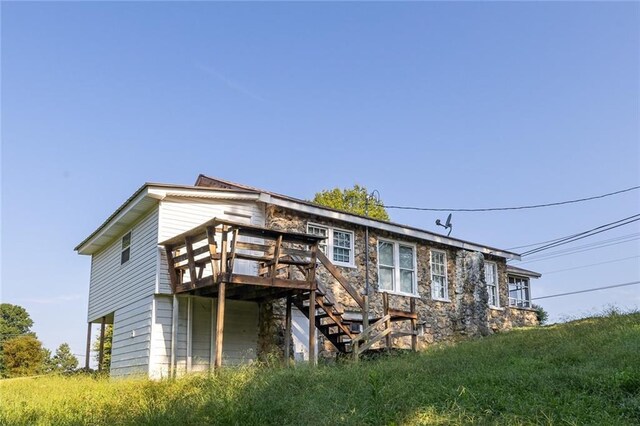 rear view of property with a wooden deck