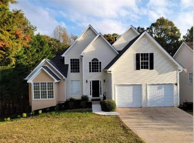 front facade with a front yard and a garage