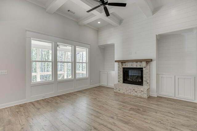 unfurnished living room with ceiling fan, beam ceiling, and light hardwood / wood-style flooring