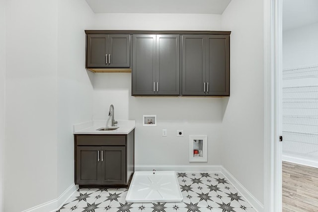 laundry room with washer hookup, cabinets, electric dryer hookup, and sink