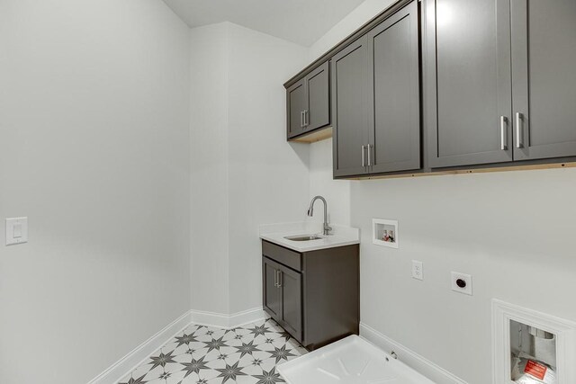 clothes washing area featuring cabinets, hookup for a gas dryer, electric dryer hookup, sink, and washer hookup