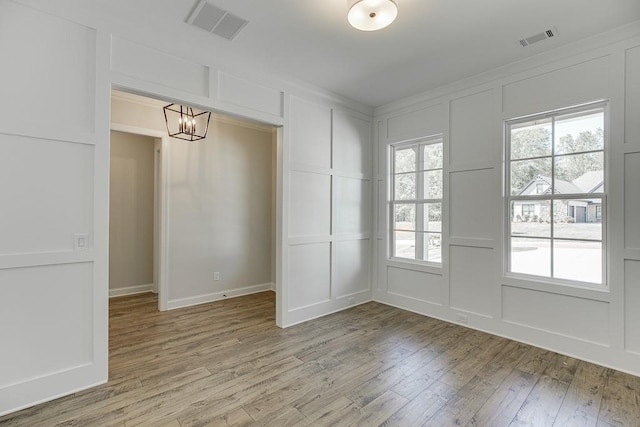 interior space featuring a notable chandelier and hardwood / wood-style flooring