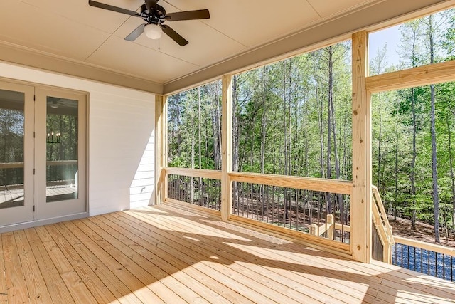 unfurnished sunroom with ceiling fan