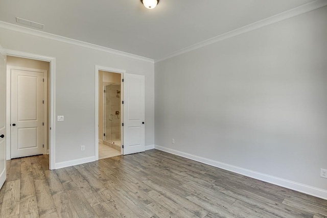 unfurnished bedroom with connected bathroom, light hardwood / wood-style flooring, and crown molding