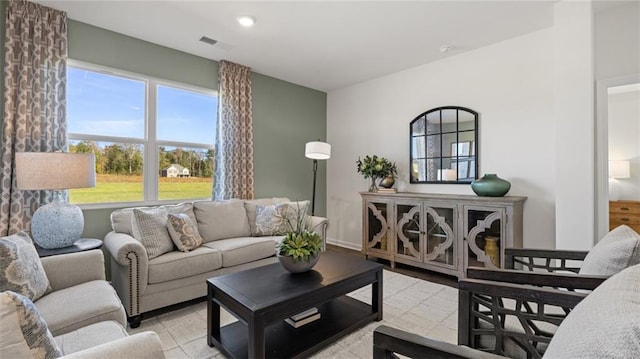 living area featuring visible vents and baseboards