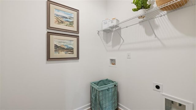 clothes washing area with laundry area, hookup for a washing machine, electric dryer hookup, and baseboards