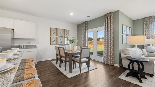 dining space with dark wood-type flooring, recessed lighting, and baseboards