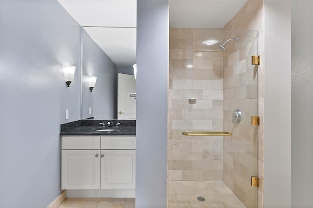 full bath with a shower stall, tile patterned flooring, and vanity