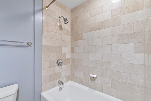 bathroom featuring toilet and  shower combination