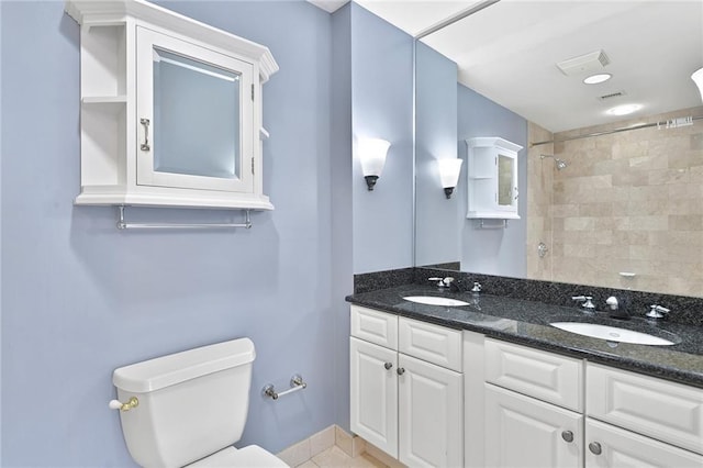 full bath featuring double vanity, a sink, walk in shower, and toilet