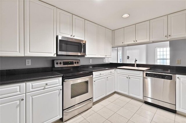 kitchen with white cabinets, appliances with stainless steel finishes, and a sink