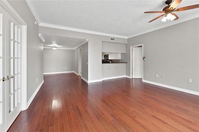 unfurnished living room featuring baseboards, a ceiling fan, dark wood-style flooring, and ornamental molding