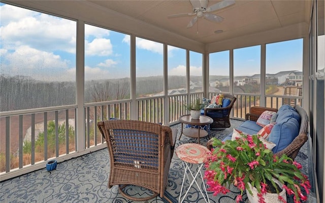 sunroom featuring a ceiling fan