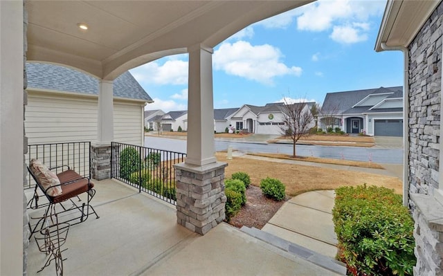 view of patio featuring a porch and a residential view