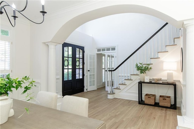 3795 Newport Bay Dr, Alpharetta, GA 30005 - entryway with arched walkways, stairway, french doors, wood finished floors, and crown molding