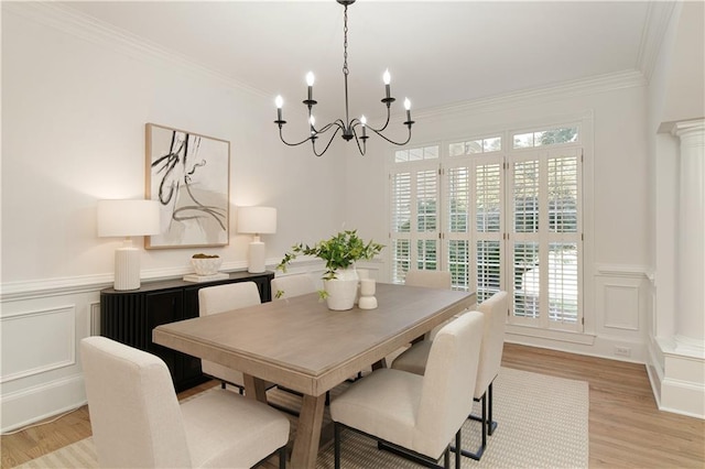 3795 Newport Bay Dr, Alpharetta, GA 30005 - dining space with a decorative wall, a chandelier, light wood-style flooring, crown molding, and wainscoting