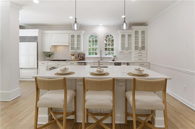 3795 Newport Bay Dr, Alpharetta, GA 30005 - kitchen with stainless steel gas stovetop, ornamental molding, tasteful backsplash, white cabinets, and glass insert cabinets