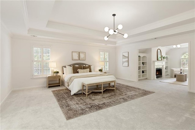 3795 Newport Bay Dr, Alpharetta, GA 30005 - bedroom with light carpet, crown molding, a raised ceiling, a chandelier, and a lit fireplace