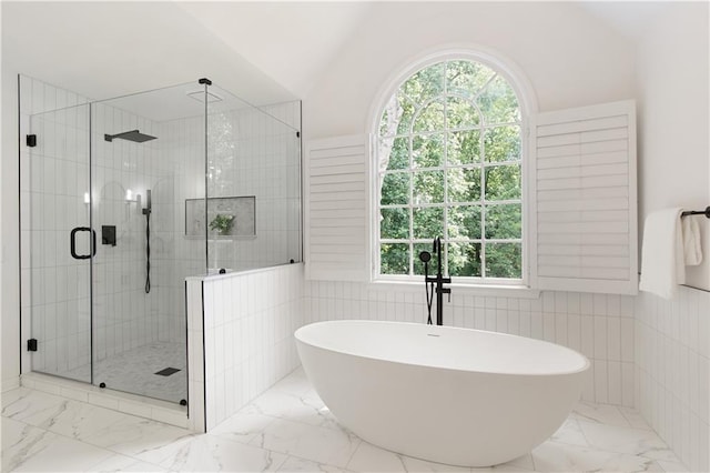 3795 Newport Bay Dr, Alpharetta, GA 30005 - bathroom with marble look tiles, a freestanding tub, a stall shower, plenty of natural light, and tile walls