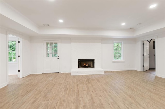 3795 Newport Bay Dr, Alpharetta, GA 30005 - unfurnished living room with a raised ceiling, light wood-style flooring, crown molding, plenty of natural light, and recessed lighting